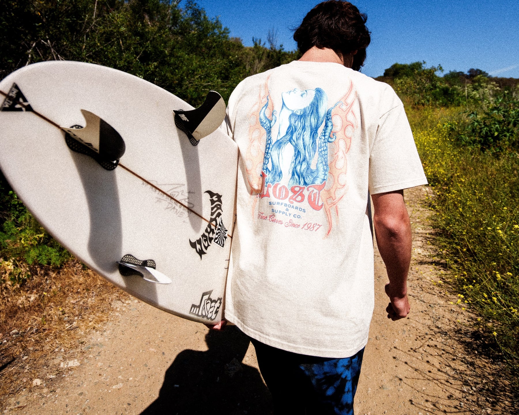 Person with surfboard in sunny outdoors