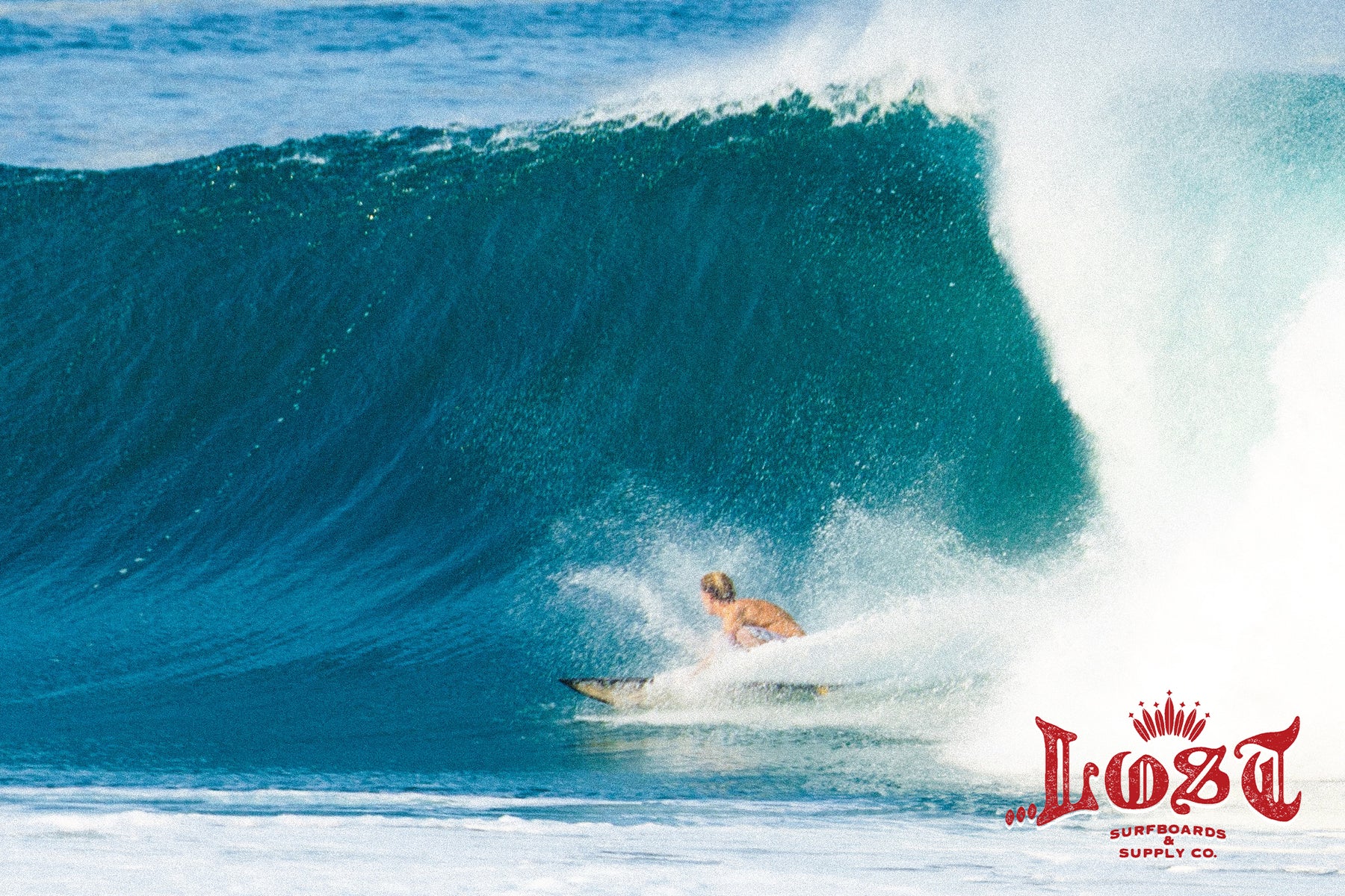 Surfer riding a massive ocean wave