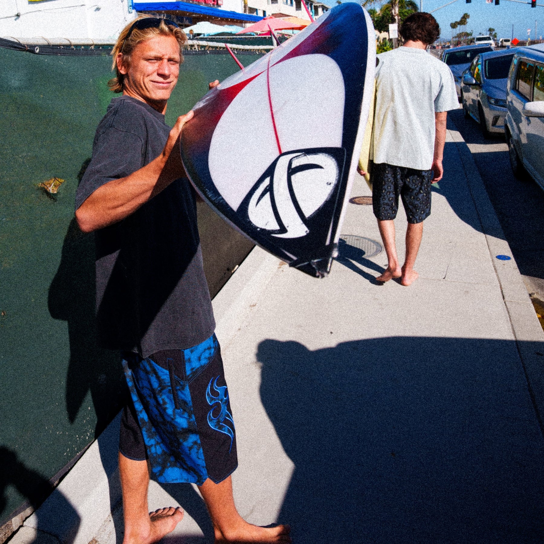 Person holding a surfboard outdoors