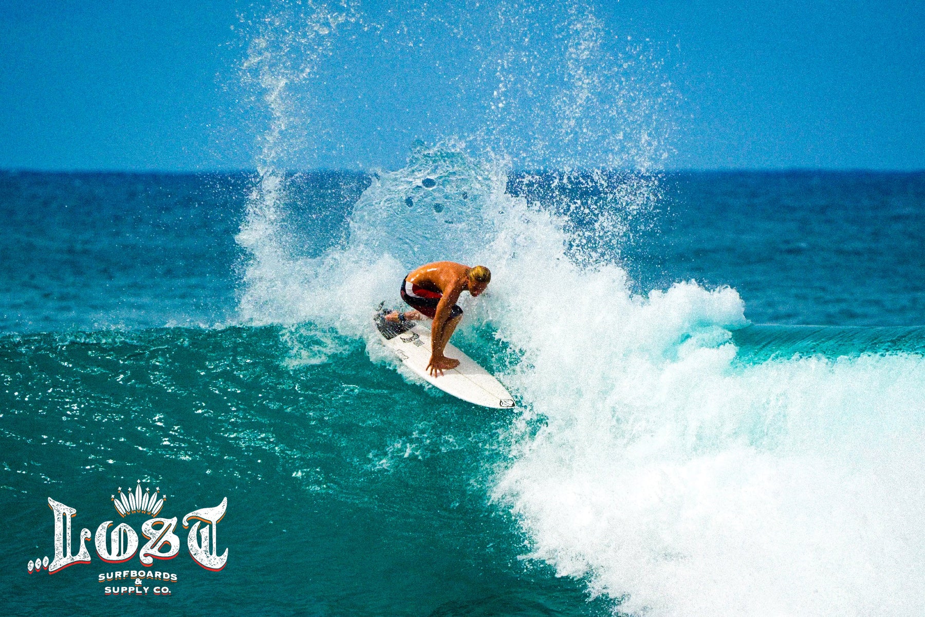 Surfboarder on turquoise wave