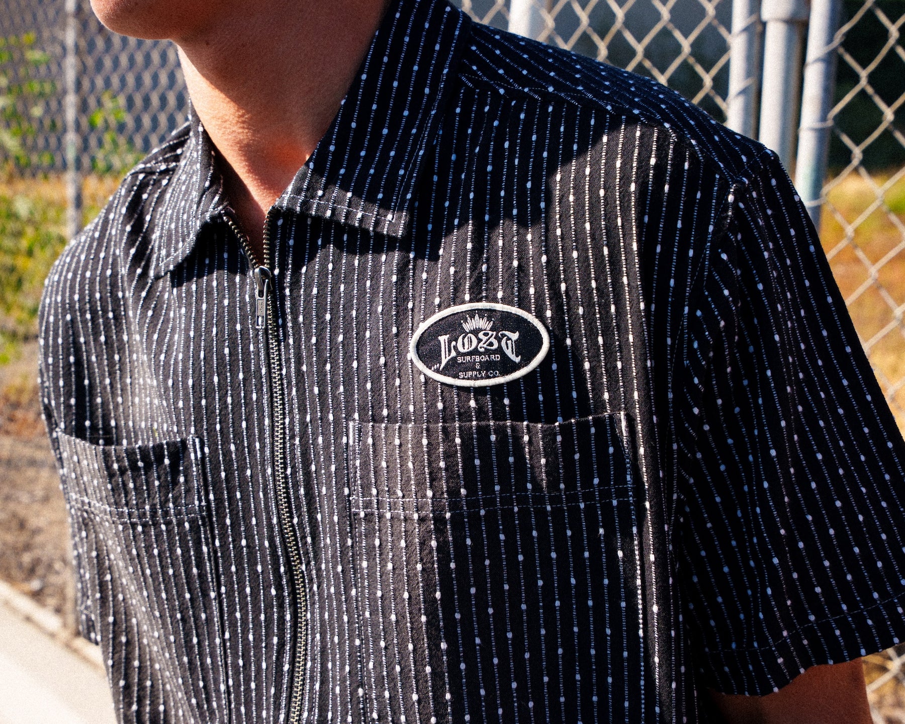 Person wearing a dark patterned shirt