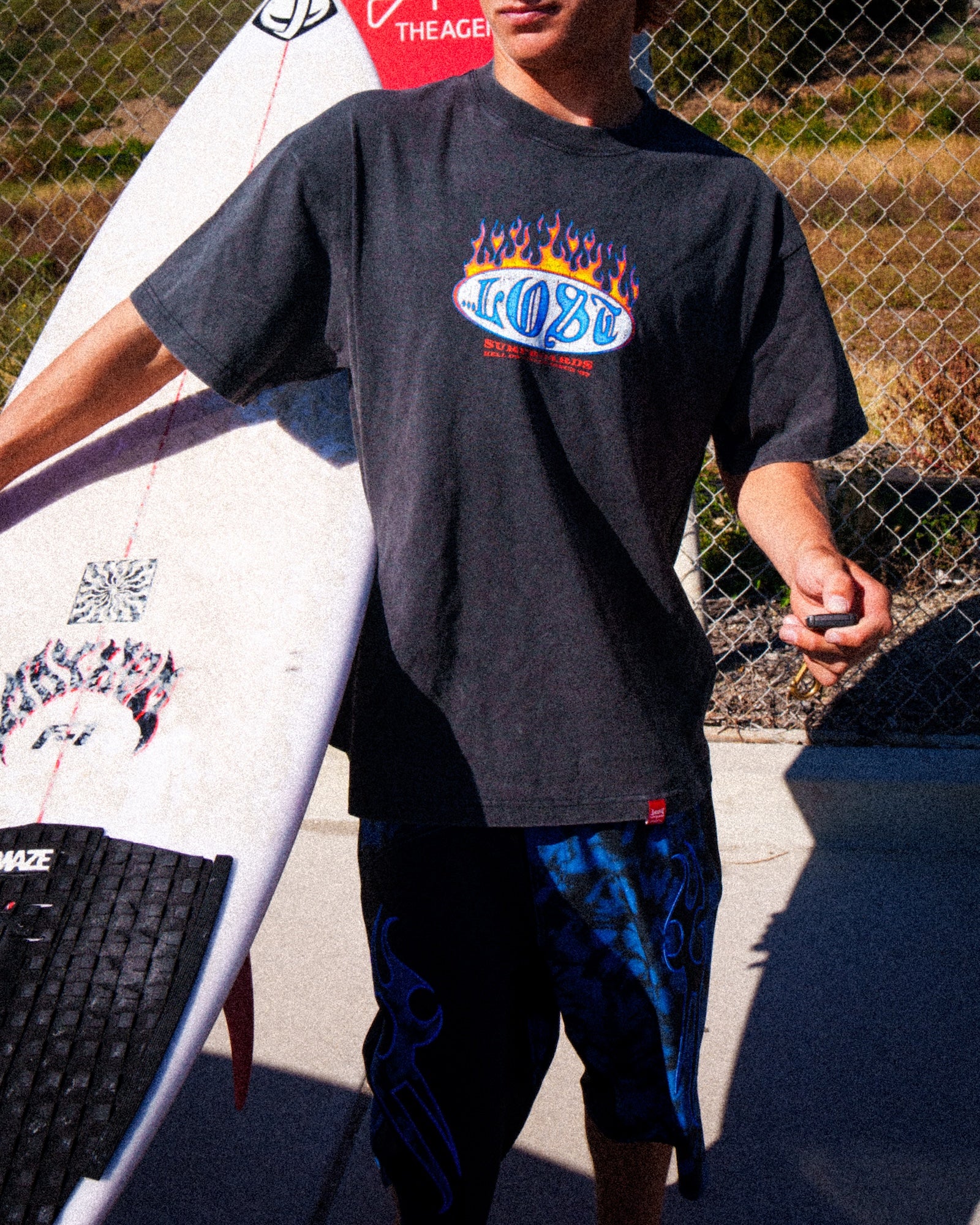 Person holding surfboard in sunny area
