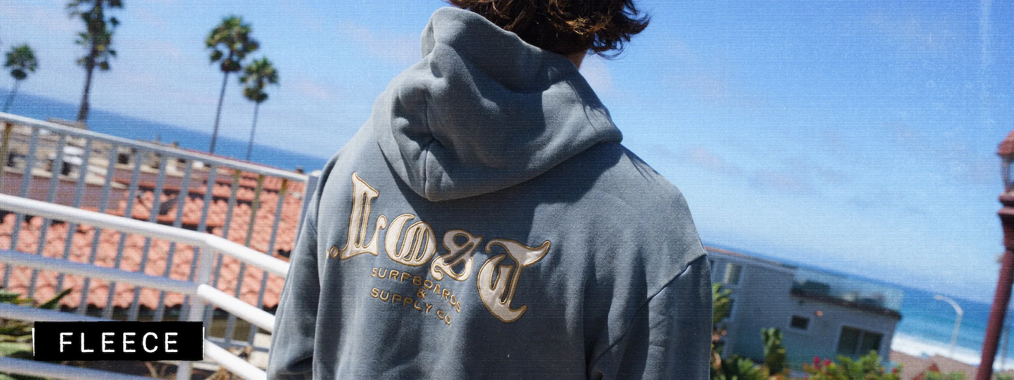 Person in hoodie with ocean view