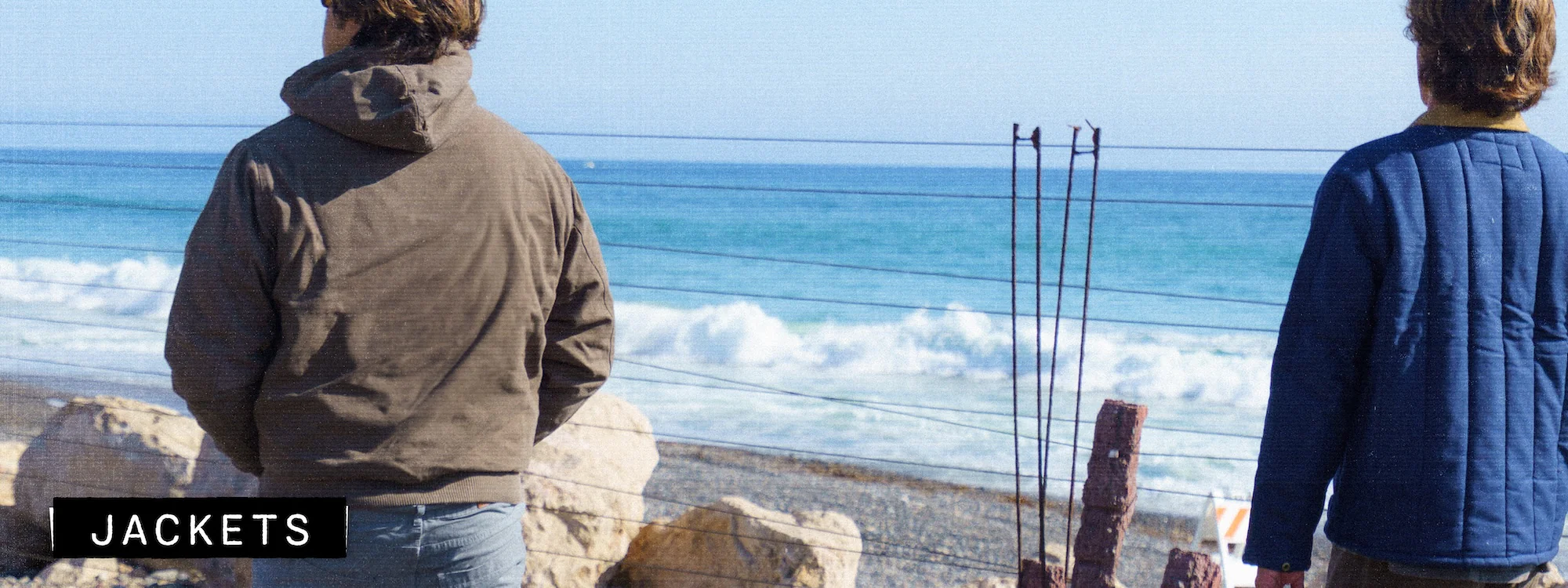 Beach view with two individuals in jackets