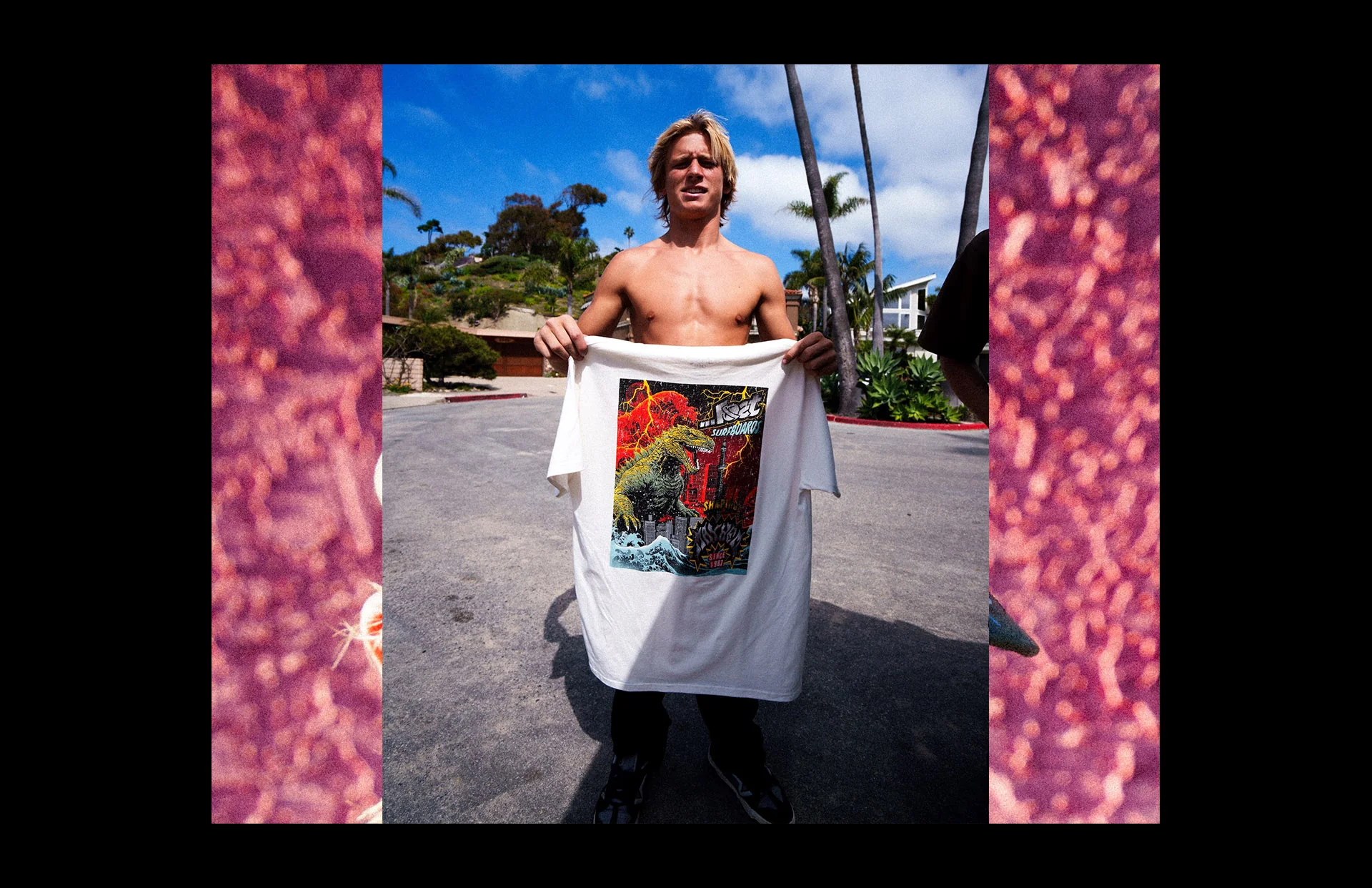 Shirtless man displaying vibrant graphic tee