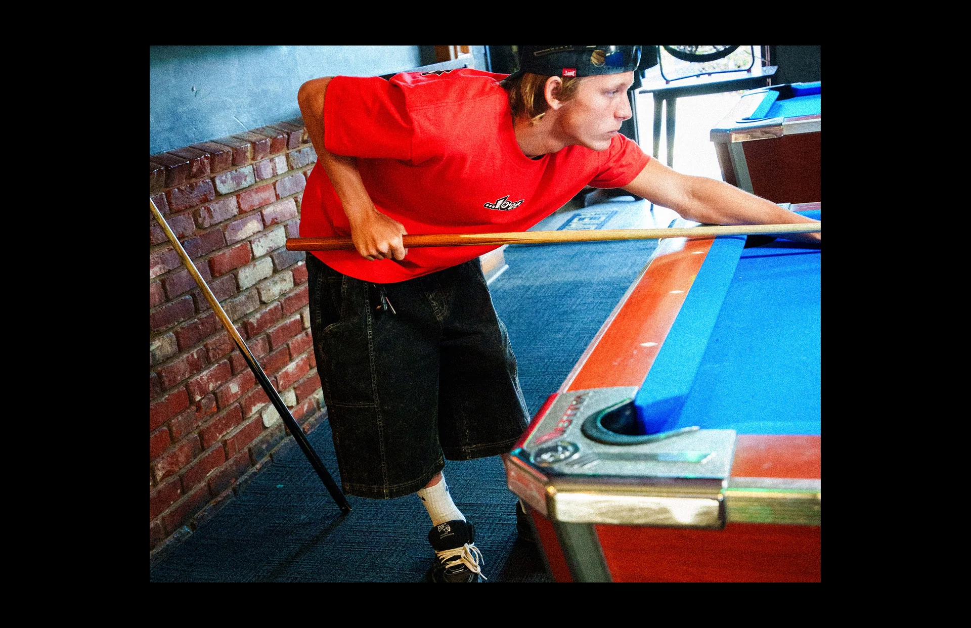 Player focusing on pool table shot.