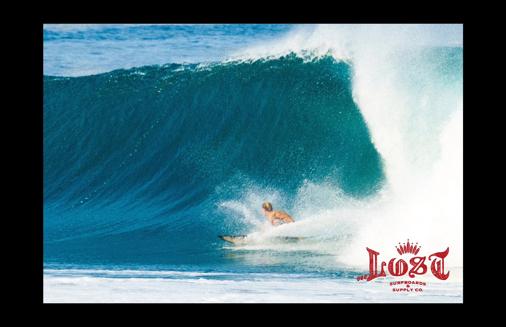 Surfer riding a massive ocean wave