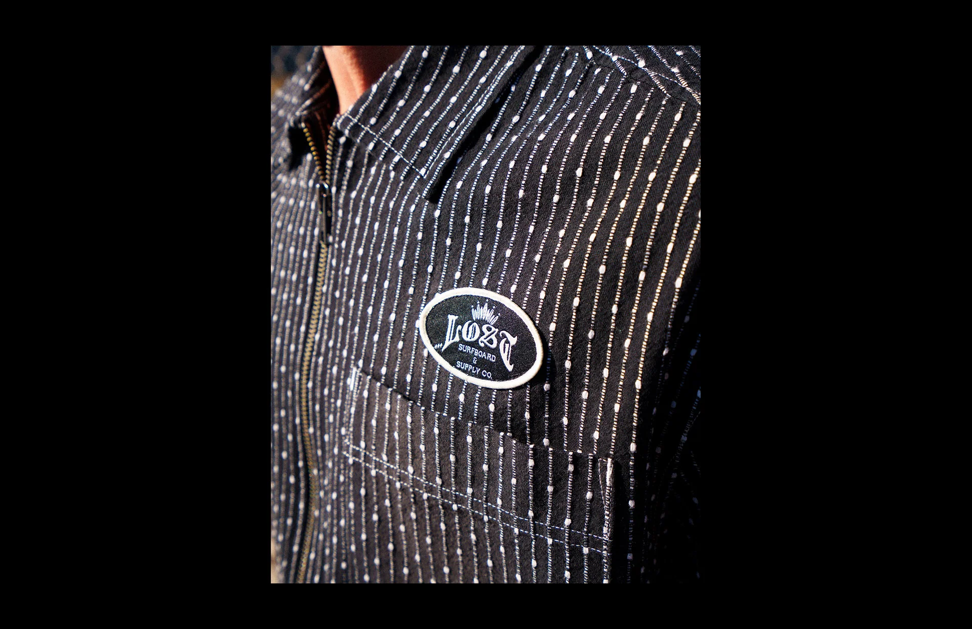 Black shirt featuring a branded patch