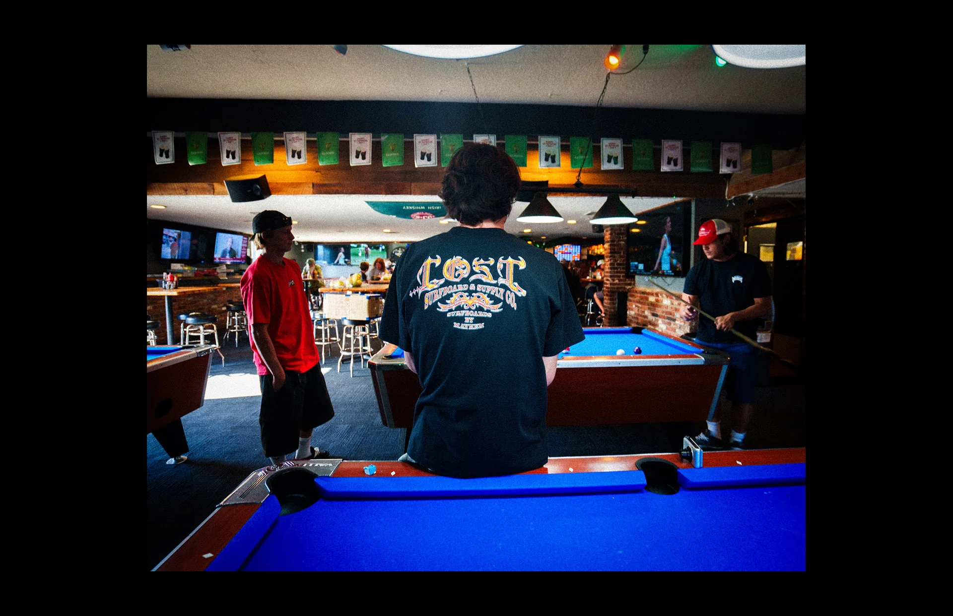 Pool tables in a lively bar setting