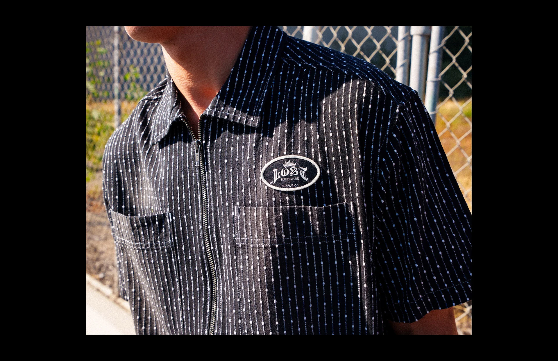 Close-up of striped shirt with logo