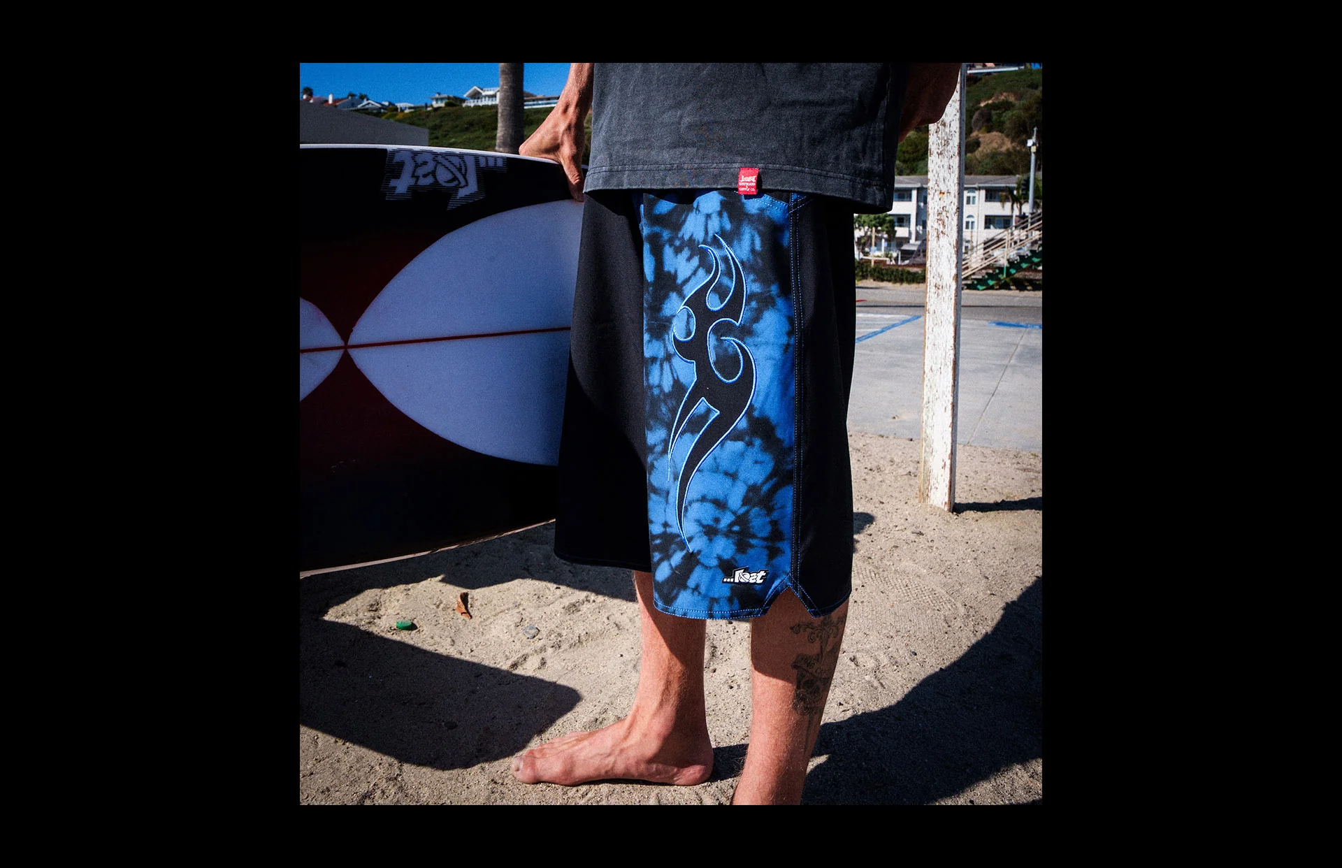 Man in blue board shorts on beach