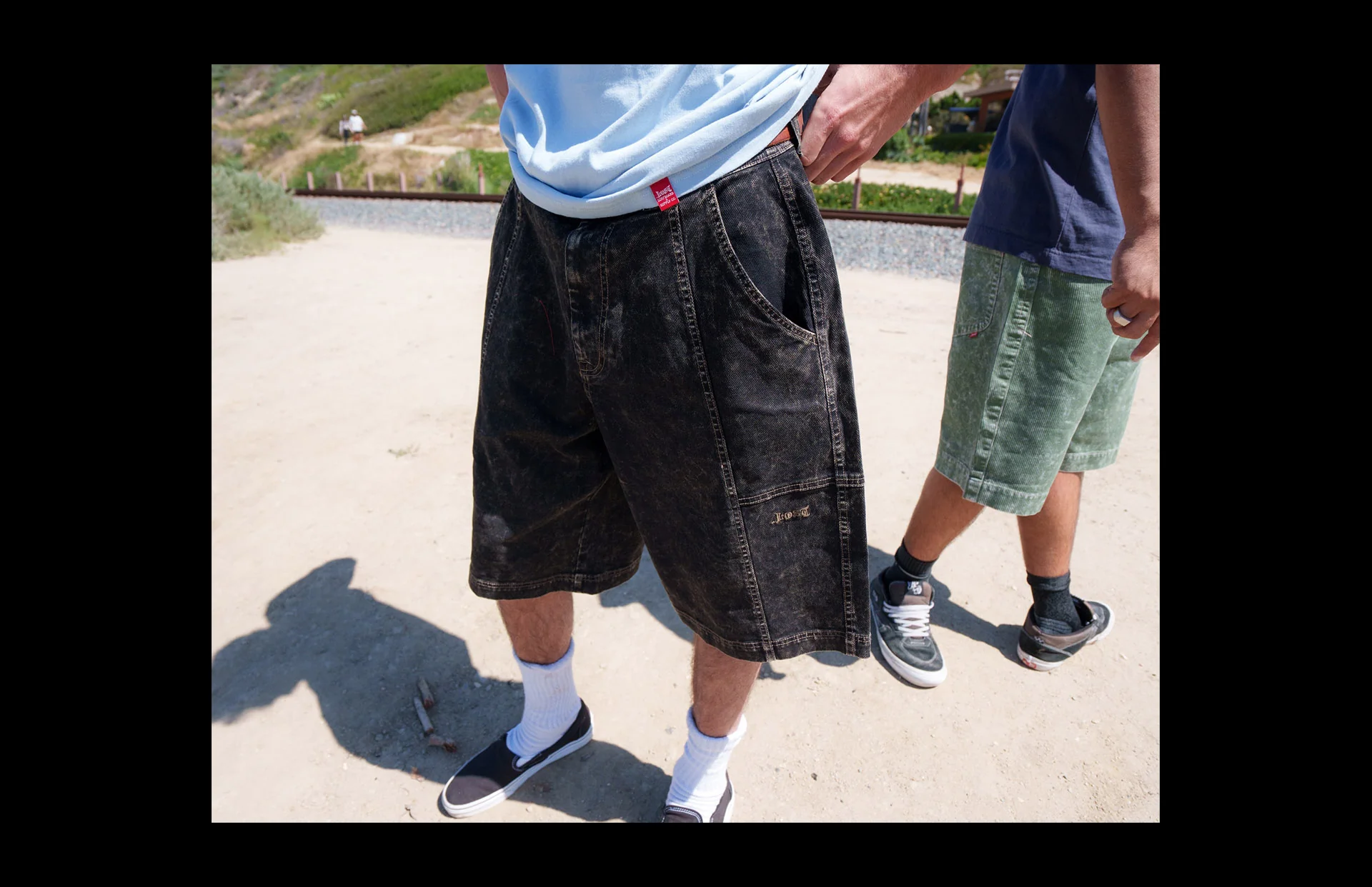 Two people wearing casual shorts outdoors